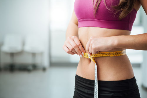 Woman Measuring Her Waist With Family Chiropractic, The Family Chiropractic Center